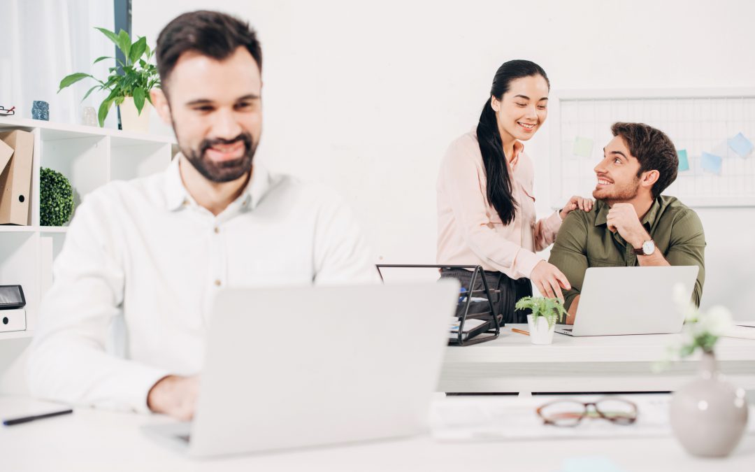 Cheerful colleagues smiling in modern office - depositphotos.com