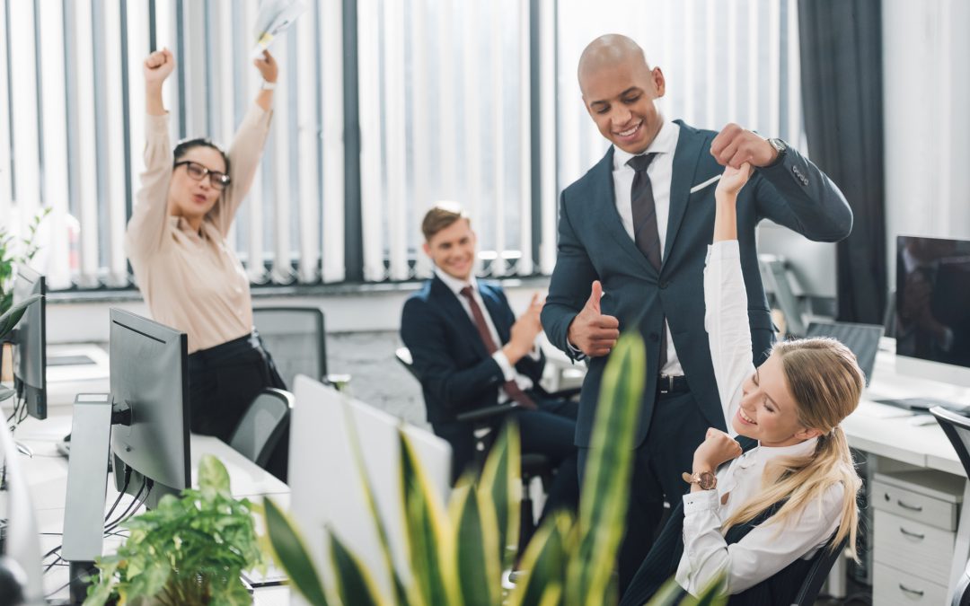 Happy young business people greeting smiling colleague in office - depositphotos.com